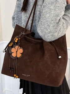 Large dark brown tote bag in faux suede with floral charm and long shoulder strap