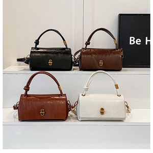 Detail of four stylish faux leather handbags in black, brown, tan, and beige with gold buckles