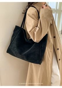 Black large capacity minimalist tote bag styled with a khaki trench coat for a retro vibe