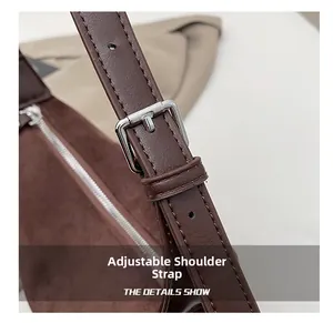 Detail of dark brown shoulder bag showing adjustable leather strap with silver buckle