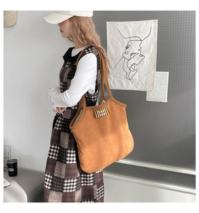 Détail du sac cabas marron en daim avec étiquette Bonjour et doublure polaire