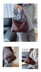 Detail view of brown faux suede shoulder bag with adjustable strap and vintage buckle
