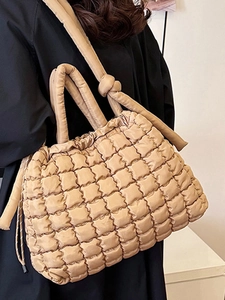 Quilted beige tote bag with square embossing and adjustable strap for casual wear