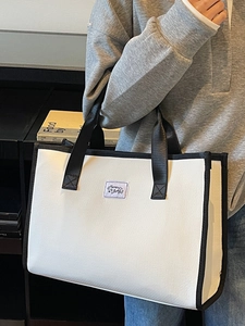 Large capacity tote bag in black and white contrast design with adjustable strap