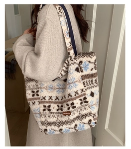 Close-up of fluffy fleece tote bag with snowflake patterns and Star-picking leather tag