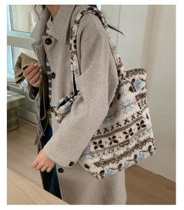 Detail of plush lamb-like wool tote bag with blue and brown geometric snowflake patterns