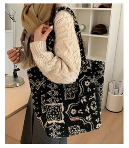 Close-up of geometric pattern plush tote bag with star-picking leather label detail