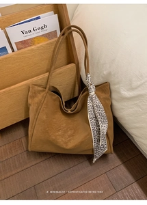 Detail of vintage brown tote bag texture with paisley scarf on wooden floor