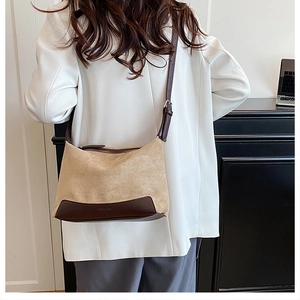 Detailed back view of a chic leopard-print shoulder bag styled with a professional white suit