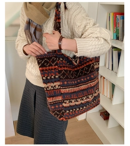 Detail of ethnic retro pattern plush tote bag with vintage leather logo patch