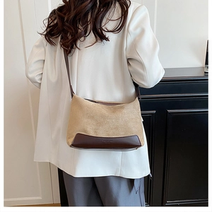 Detail of khaki frosted leather shoulder bag featuring Vogue & Bags embossed lettering