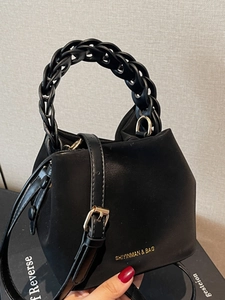 Minimalist black bucket shoulder bag with thick chain handle and adjustable strap