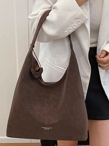 Brown suede leather tote bag for women showing a stylish shoulder carry on a white blazer
