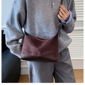 Detail view of the brown frosted leather crossbody bag with adjustable shoulder strap