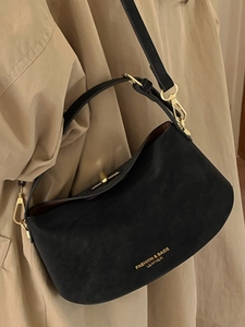 Sac bandoulière minimaliste en cuir noir avec détails dorés et fermoir tournant élégant