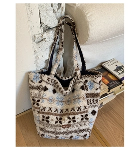 Detail view of plush tote bag with Nordic geometric patterns and snowflake prints