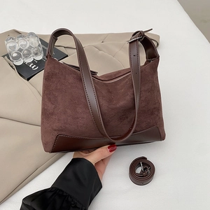 Detailed view of dark brown frosted suede shoulder bag with dual strap options