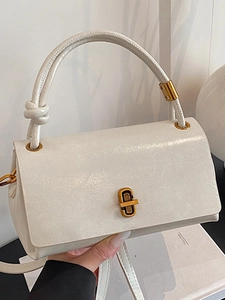 Elegant cream-colored patent leather handbag with vintage gold twist lock and top handle