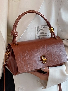 Brown vintage faux leather handbag with golden metal lock and twisted handle for women