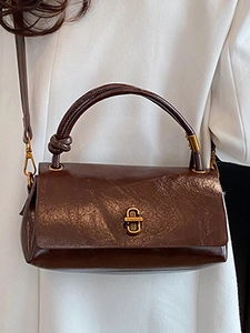 Deep brown vintage leather handbag with gold turn-lock and top handle for women
