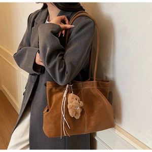 Brown faux suede tote bag featuring white contrast stitching and a cute bear charm