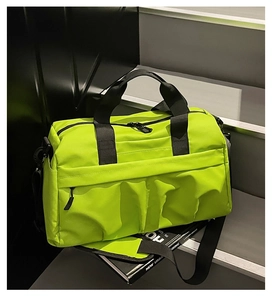 Detail view of neon green travel bag with side pleated pockets and black webbing straps
