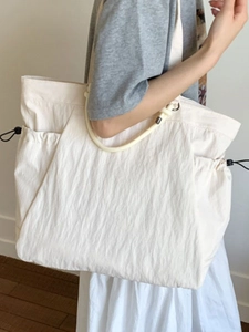 Minimalist large capacity white nylon tote bag with drawstring side pockets for travel