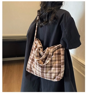 Vue détaillée d'une personne portant un sac cabas en tricot à carreaux pour l'automne