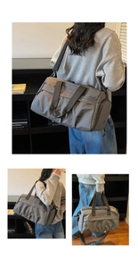 Detail of grey waterproof gym bag showing separate shoe compartment and adjustable straps