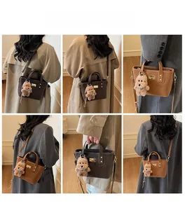 Detailed views of stylish women's matte leather tote bag with plush bear charm and strap