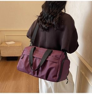 Deep purple travel bag with wide shoulder strap showing back view and large capacity