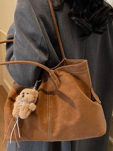 Minimalist large brown tote bag with white stitching and bear charm for women