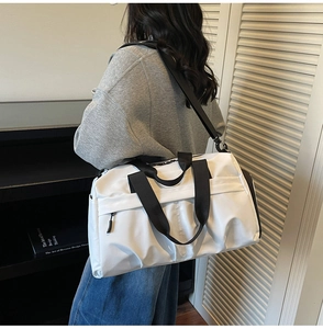 Waterproof travel bag with large capacity and dry wet separation shown on model shoulder