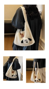 Detail of soft cream knit tote bag with 3D sheep decor and brown toggle closure