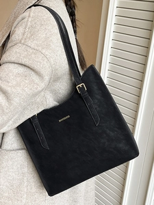 Minimalist black large capacity tote bag with adjustable shoulder straps and gold logo