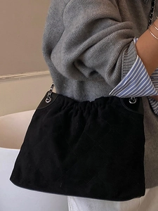 Quilted black suede bucket bag with stylish metal chain strap for women