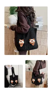 Detail showing oversized black fuzzy tote bag with cute plush animal charms on surface