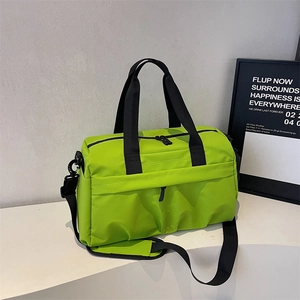 Macro detail of bright green nylon gym bag with adjustable strap and dual zipper closure