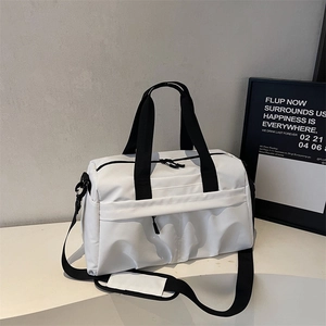 Detail of waterproof travel bag featuring dual zippers and adjustable black shoulder strap