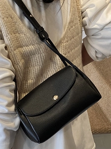 Minimalist black pebble leather crossbody bag for women with gold round buckle detail