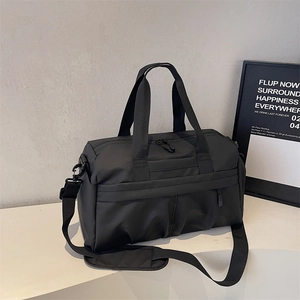 Close-up of waterproof black gym bag with durable nylon texture and adjustable shoulder strap