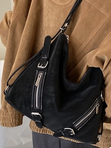 Retro black faux suede hobo bag with silver zipper accents and white stitching detail
