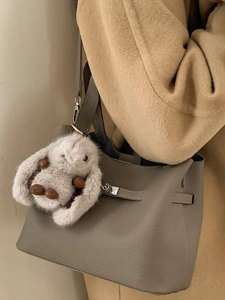 Fashionable grey lychee leather bucket bag with silver lock and plush rabbit charm decor