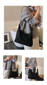Detail of black suede Hobo bag with white contrast stitching and gold metal chain strap