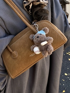 Retro brown suede shoulder bag with cute teddy bear charm and fashion lettering detail