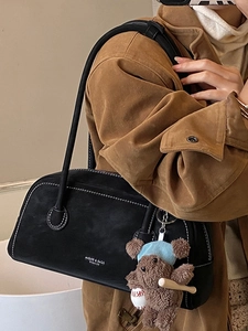 Vintage black faux suede shoulder bag with contrast stitching and bear charm