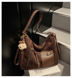 Détail du sac cabas en daim café avec poche en cuir marron et boucle dorée