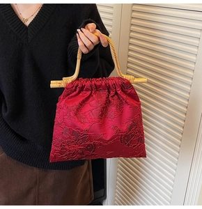 Detail of red floral jacquard tote bag with bamboo handle and drawstring closure