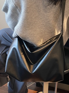 Minimalist large black PU leather shoulder bag for women shown on a model for daily use