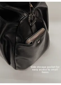 Gros plan de la poche latérale en cuir noir pour ranger facilement un téléphone portable